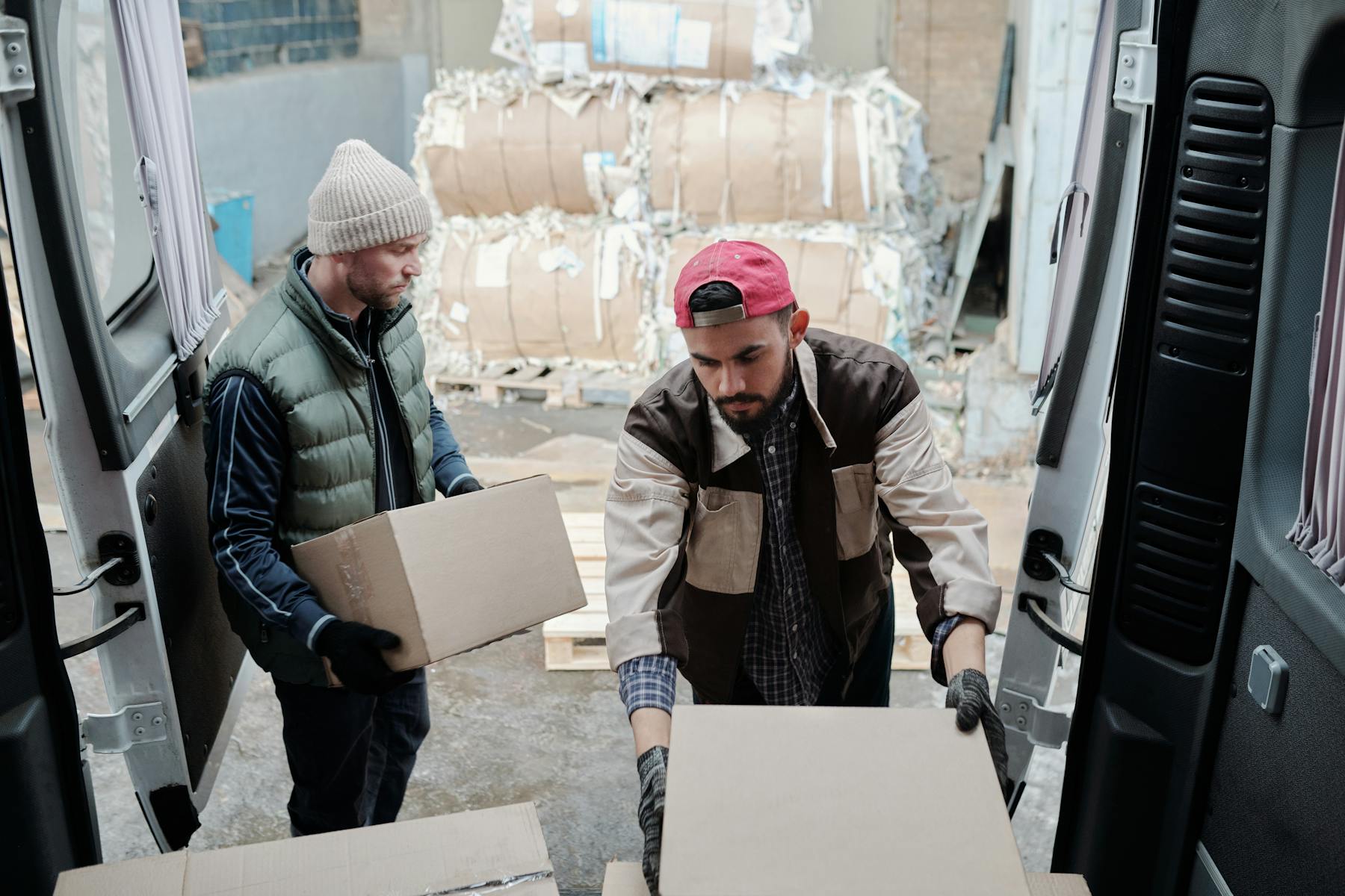 Crew unloading cartons from a van