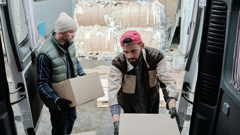 Crew unloading cartons from a van