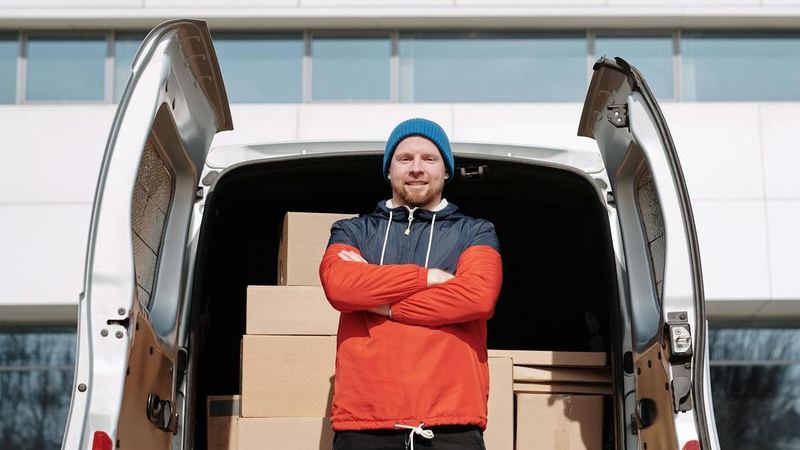 Team loading bulk order cartons into a van