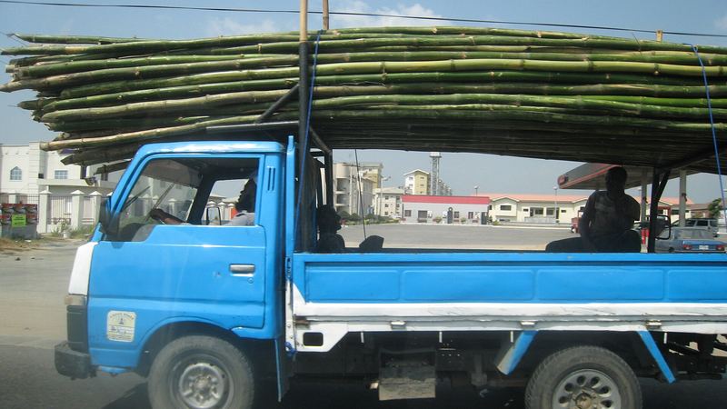 A light truck carrying a long load in Lagos