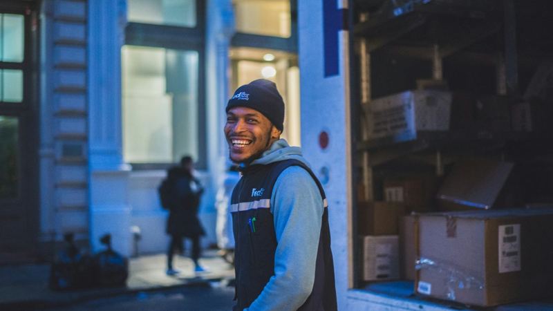 A courier at a delivery door