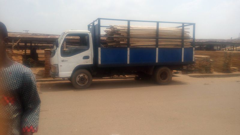 A light truck loading planks at Bodija market, Ibadan