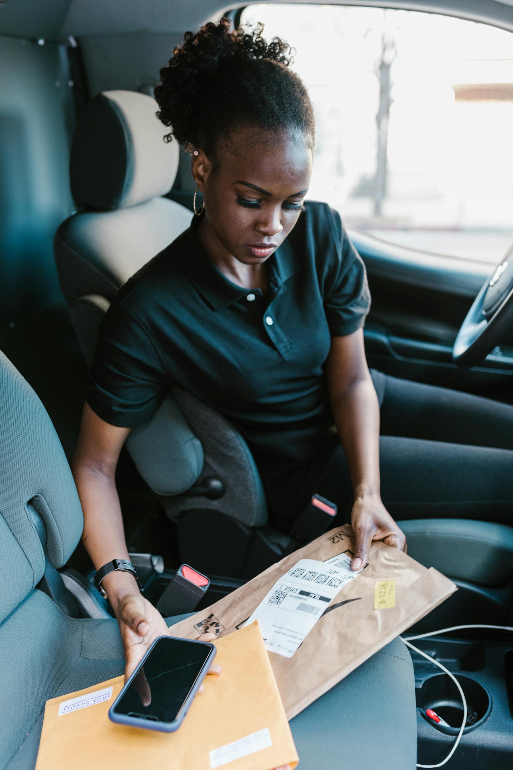 Black woman move driver checking route in a car